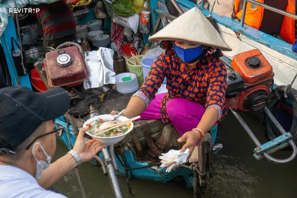 Hu tieu noodle soup served from a food boat at Cai Rang floating market