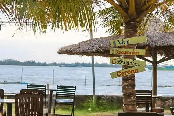 Beachfront cafe at Can Tho Beach with shaded seating and panoramic Hau River views in Can Tho city