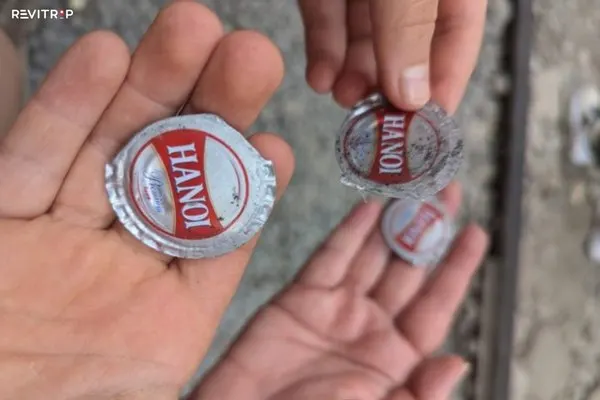 Bottle cap pressed at Hanoi Train Street