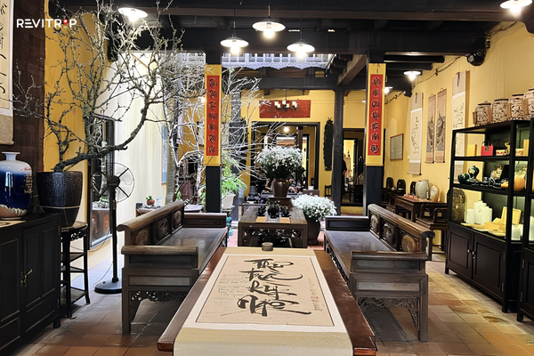 Traditional interior of Ma May Heritage House with wooden furniture and an open courtyard in Hanoi Old Quarter