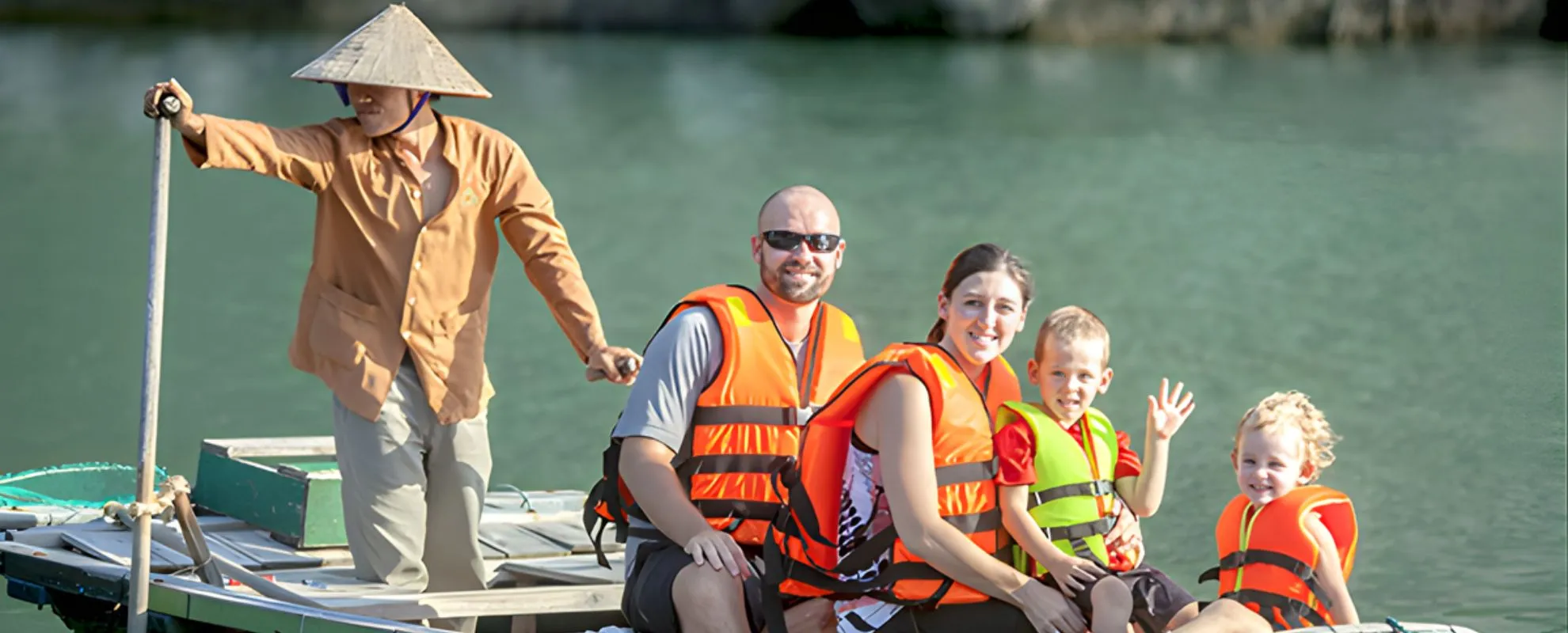 Family boat trip in Vietnam with children wearing life jackets, a fun family-friendly travel experience